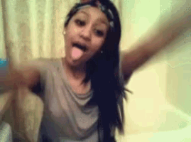 a girl with a headband on her head sticks out her tongue