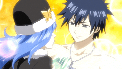 a man and a woman are standing next to each other and the man is wearing a necklace that says fairy tail on it