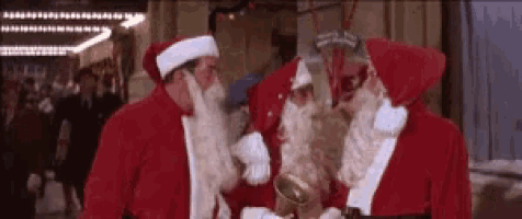 three men dressed as santa claus are standing next to each other .