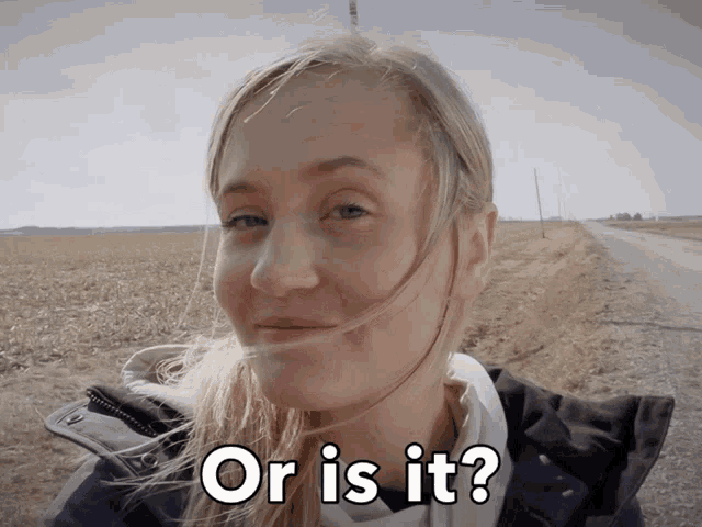 a woman stands in front of a field with the words " or is it " written on her face