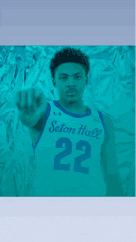 a basketball player from seton hall is pointing his finger at the camera