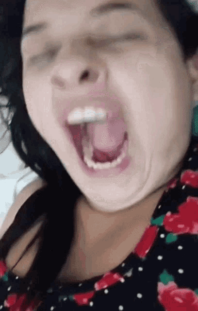 a close up of a woman with her mouth open