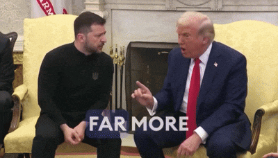 two men are sitting on a couch and one of them has a sign that says " far more "