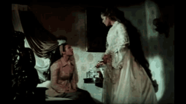 a woman in a white dress stands next to another woman