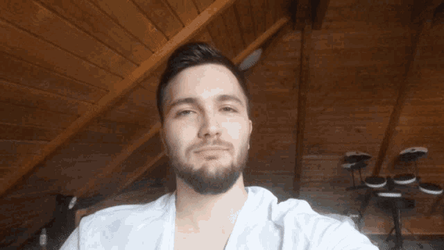 a man with a beard is taking a selfie