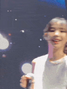 a girl is smiling and holding a microphone in front of a screen that says winter rabbit