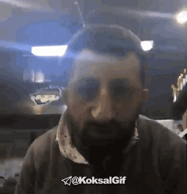 a man with a beard and sunglasses is looking at the camera with the hashtag @koksalgif in the corner .
