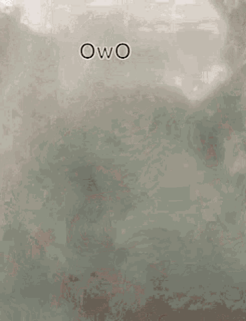 a black and white photo of a man in a superhero costume with the word owo on his face .