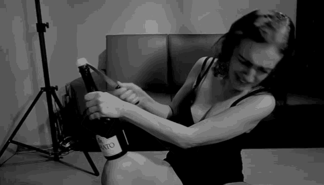 a woman is holding a bottle of bruto wine