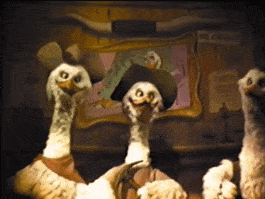 a group of cartoon birds wearing cowboy hats are standing in front of a no cruelty sign