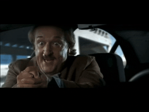 a person is driving a car with a rear view mirror