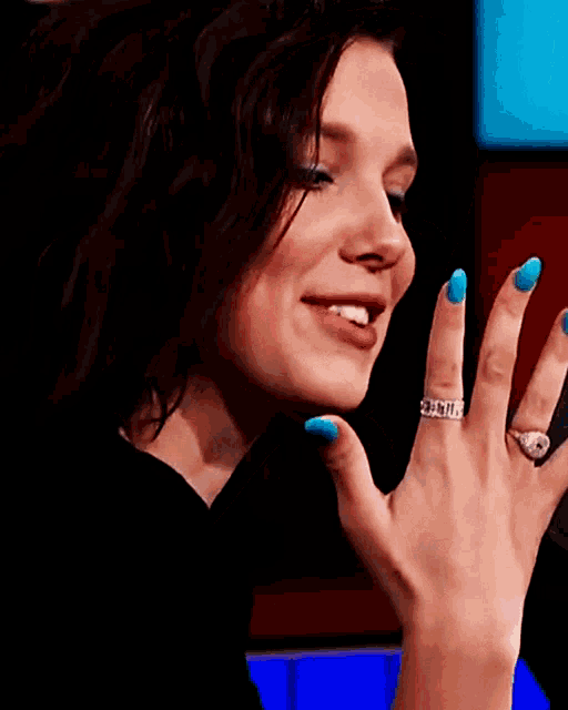 a close up of a woman 's hand with a ring on it