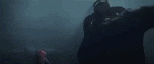 a blurry picture of a person holding a sword with a lightning bolt coming out of it .