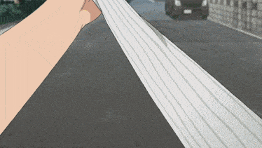 a person is holding a piece of paper on the street