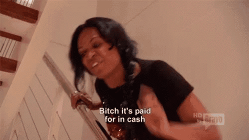 a woman is standing on a set of stairs and says `` and the aston , bitch '' .