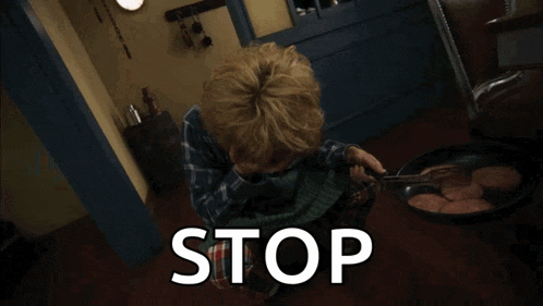 a young boy in a plaid shirt and tie is screaming and says stop
