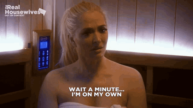 a woman in a sauna with the words wait a minute i 'm on my own on her chest