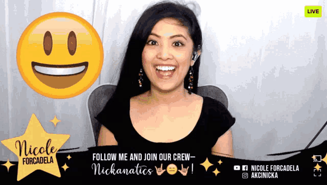 nicole forcadela is smiling in front of an emoji