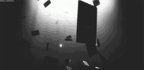 a black and white photo of a bunch of cards falling from the ceiling .