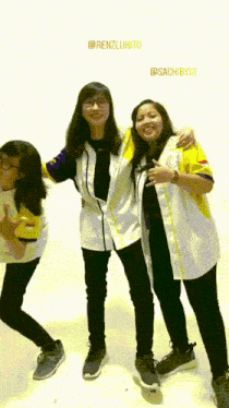 three girls are posing for a picture and one of them is wearing a shirt that says @sachib13