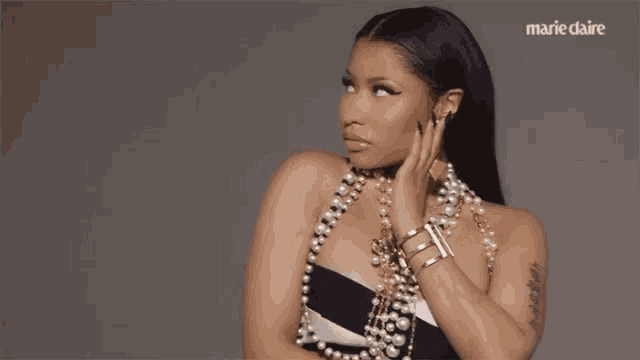 a woman wearing a pearl necklace and bracelets is featured in marie claire