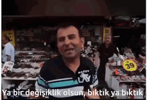 a man in a lay shirt is standing in front of a store