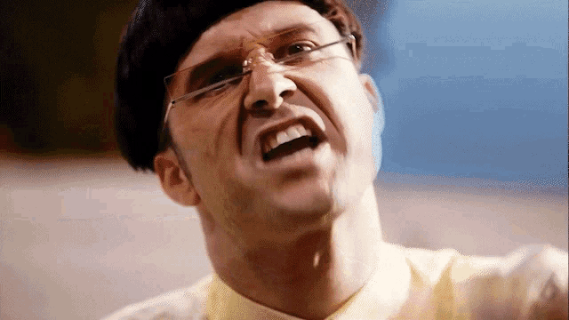 a close up of a man wearing glasses and a wig making a funny face
