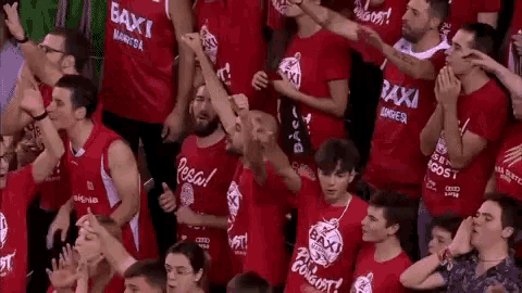 a crowd of people wearing red shirts with baxi on them