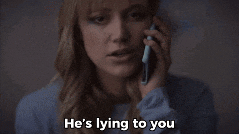 a woman is talking on a cell phone while saying he 's lying to you .
