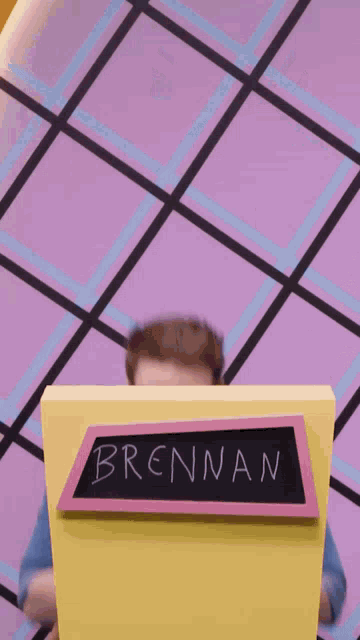 a man stands behind a podium that says brennan on it