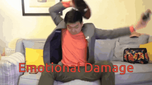 a man sitting on a couch with the words emotional damage written on the bottom