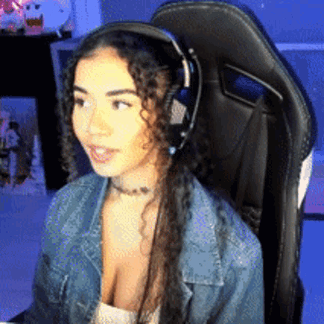 a woman is wearing headphones while sitting in a chair .