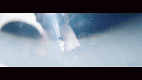 a close up of an airplane 's exhaust pipe with smoke coming out of it .