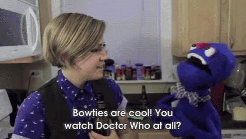 a woman talking to a puppet that says bowties are cool
