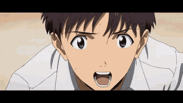 a close up of a boy 's face with his mouth wide open