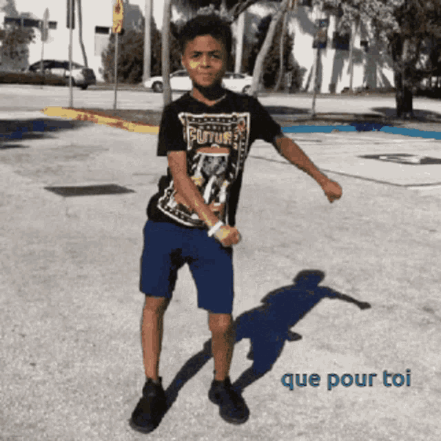 a young boy in a futura shirt is dancing