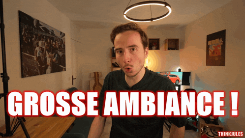 a man stands in front of a sign that says grosse ambiance !