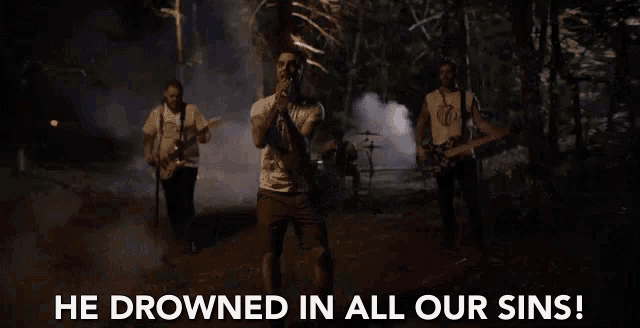 a group of men are playing instruments and singing into microphones while a man says he drowned in all our sins .