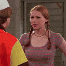 a woman with pigtails is talking to a man wearing a chef 's hat