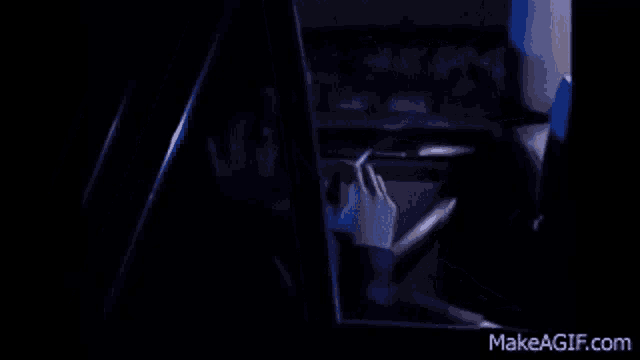 a man is smoking a cigarette while looking out of a car window .