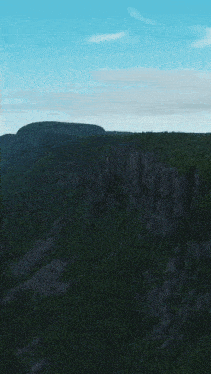 an aerial view of a cliff overlooking the ocean