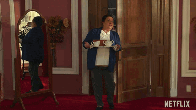 an advertisement for netflix shows a woman holding a tray with two cups of coffee on it