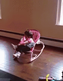 a little girl in a pink rocking chair