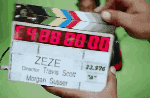 a person is holding a clapper board that says zeze on it
