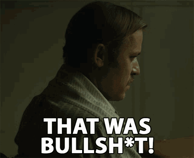 a man with a mustache is sitting at a desk and says that was bullshit