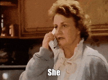 a woman is talking on a cell phone and the word she is on her face