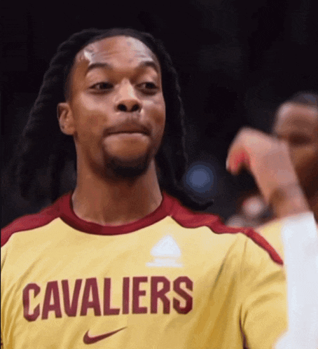 a man wearing a cavaliers jersey looks to the side