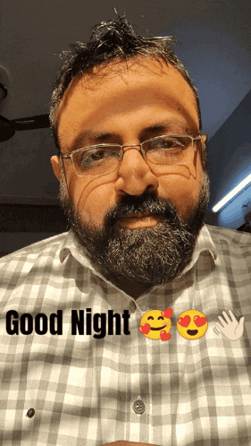 a man with a beard wearing glasses and a plaid shirt says " good night "