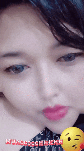 a close up of a woman 's face with a yellow smiley face behind her that says muaccochhhh