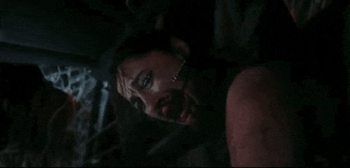 a close up of a woman with blood on her face .